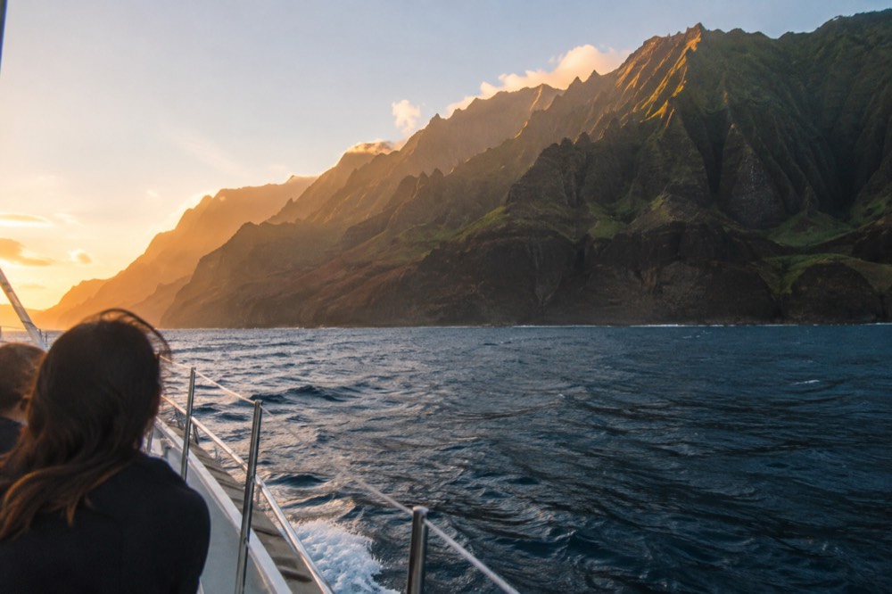 Golden evening light on the Napali Coast cliffs seen from the water