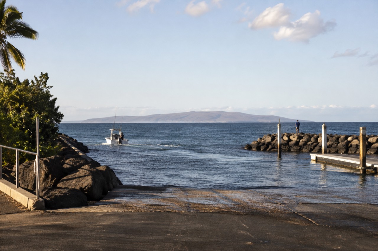 The low arid profile of Niihau island seen across open channel water under a wide sky