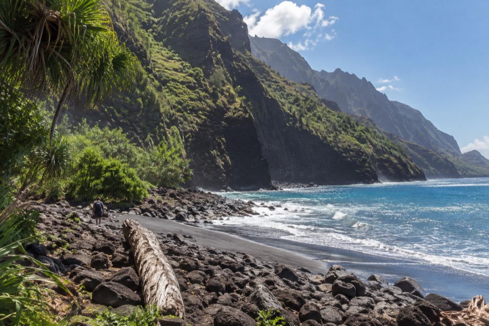 Tall green cliffs along a wild coastline with turquoise water below