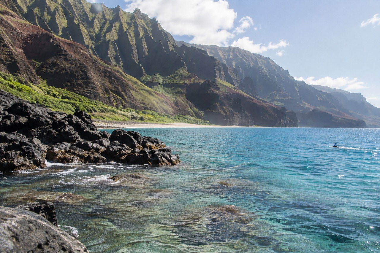 Clear turquoise water over a coral reef along a tropical coastline