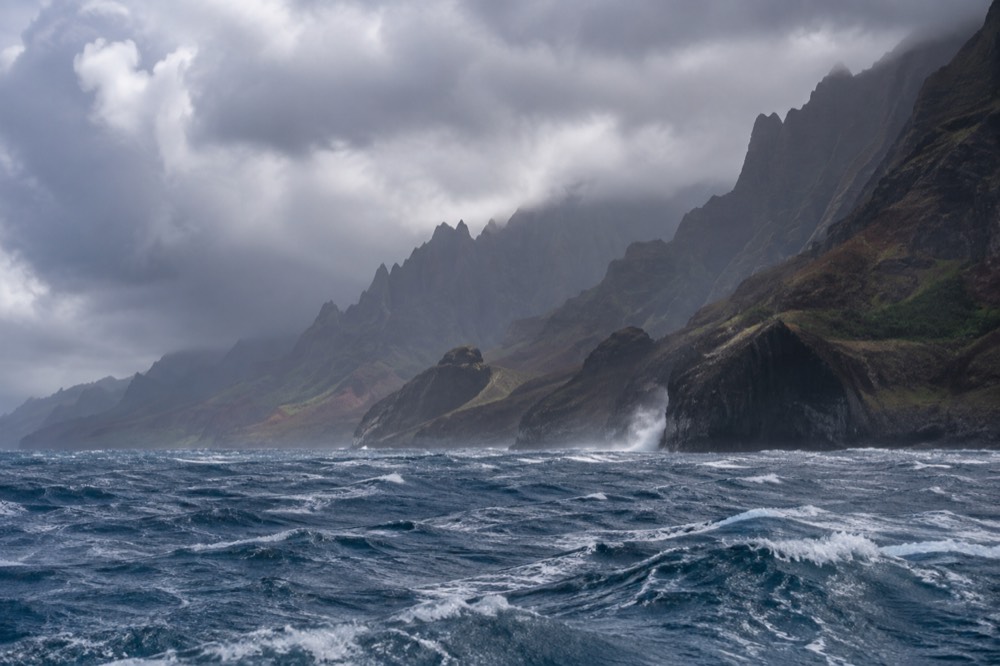 White-capped ocean along the Napali Coast under a cloudy sky