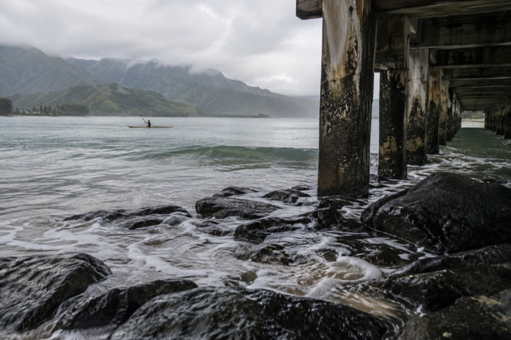 Shorebreak lapping the foot of Hanalei Bay's pier pilings