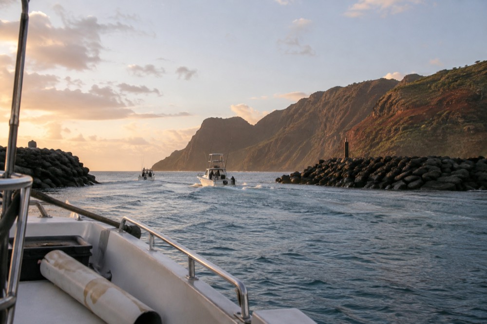 Small boats moored in a quiet harbor at dawn