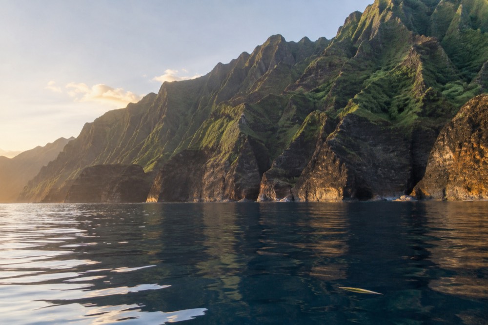 Glassy calm ocean along the Napali Coast on a clear summer morning