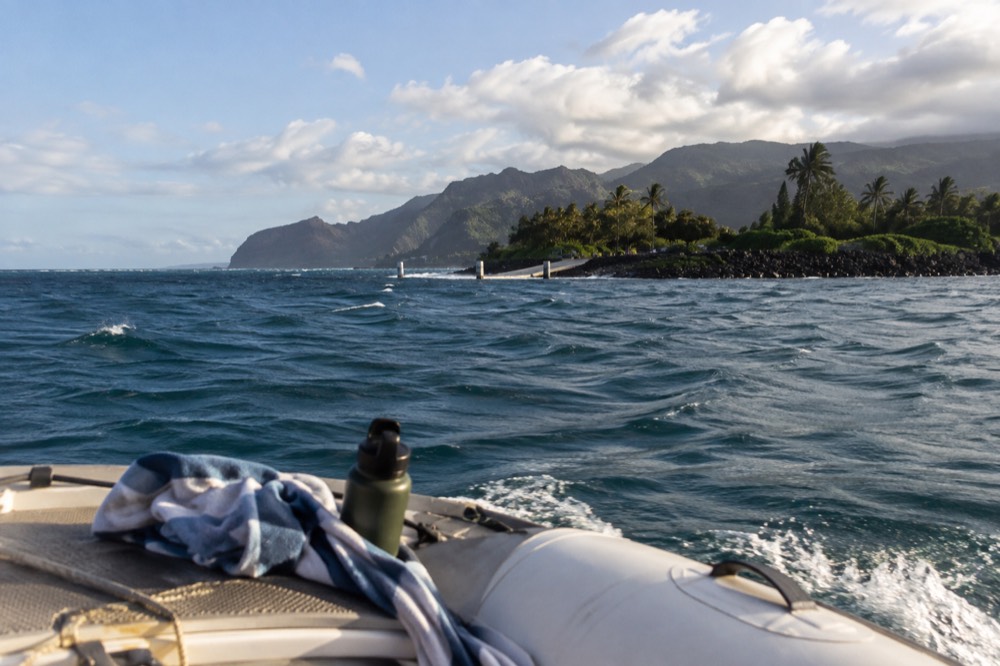 Open ocean water with small waves and a distant coastline