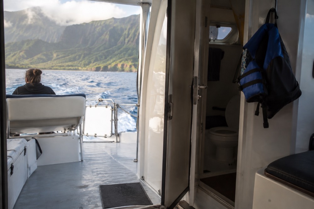 The shaded cabin doorway of a power catamaran underway off Port Allen