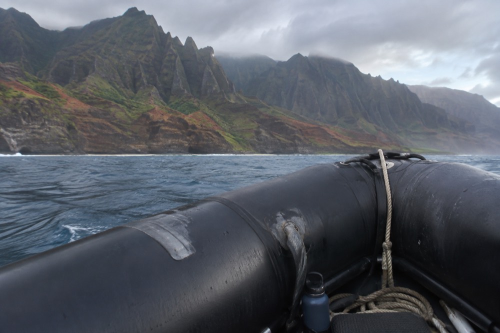 Close on the twin tubes and rigid hull of a raft idling off the Napali Coast
